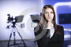 Television presenter recording in news studio.Female journalist anchor presenting business report,recording in television studio