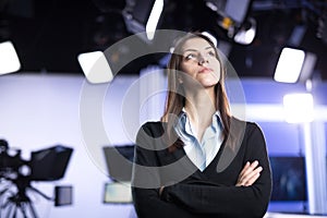 Television presenter recording in news studio. Female journalist anchor presenting business report, recording in television studio