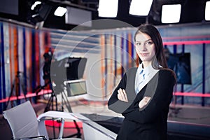 Television presenter recording in news studio.Female journalist anchor presenting business report,recording in television studio