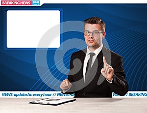 Television reporter telling breaking news at his studio desk with copy space