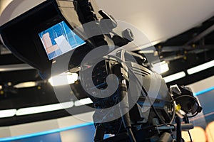 Television studio with camera and lights - recording TV show. Shallow depth of field