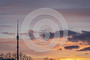 Television tower Ostankino in Moscow against sunset cloudy sky in background. TV tower