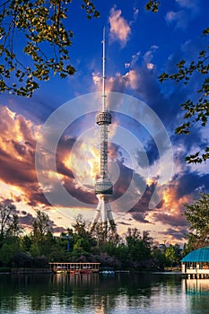 television TV tower in Tashkent in Uzbekistan with a reflection in the water of river under a beautiful blue sky in