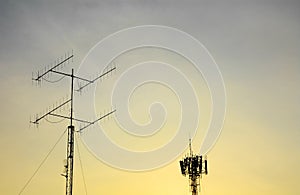 Televisions antenna and telecommunication tower antenna with sunset background