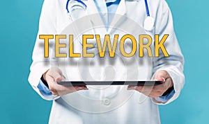 Telework theme with a doctor using a tablet pc