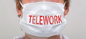 Telework theme with person wearing a protective face mask