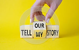 Tell our or my story symbol. Businessman hand turns wooden cubes and changes the words Tell my story to tell our story. Beautiful