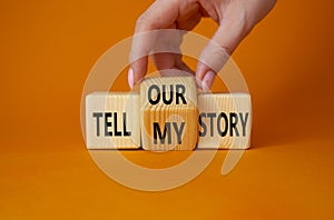 Tell our or my story symbol. Businessman hand turns wooden cubes and changes the words Tell my story to tell our story. Beautiful