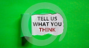 Tell us what you think symbol. Words `tell us what you think` appearing behind torn green paper. Business and `tell us what you