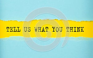 TELL US WHAT YOU THINK text on the torn paper , yellow background