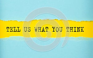 TELL US WHAT YOU THINK text on the torn paper , yellow background photo