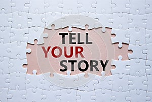 Tell your story symbol. Concept words Tell your story on white puzzle. Beautiful pink background. Business and Tell your story