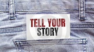 TELL YOUR STORY words on a white paper stuck out from jeans pocket. Business concept