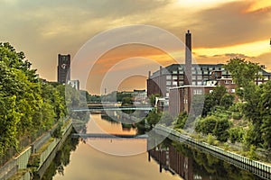 The Teltow Canal in Berlin-Tempelhof, Germany, overlooking bridges and old factory buildings in the light of the sun