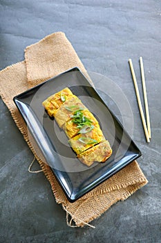 Telur dadar gulung or Tamagoyaki or Japaneses egg roll. Gyeran Mari or Korean Rolled Omelette. fried egg.