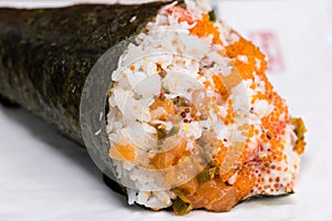 Temaki, nori seaweed cone stuffed with rice, salmon and caviar accompanied by wasabi and gari