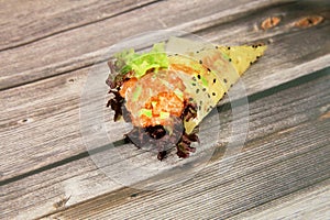 Temaki Sushi salmon Hand Roll wrapped Mamenori seaweed served on wooden board background