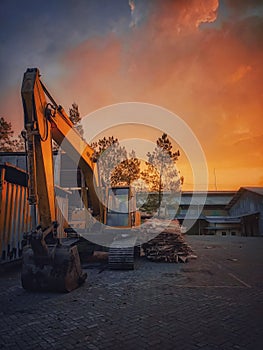 Temanggung, 17 july 2021 heavy equipment vehicle that is stopped with the best view of the orange sky or the sunset