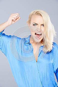 Temperamental woman raising her fist in anger