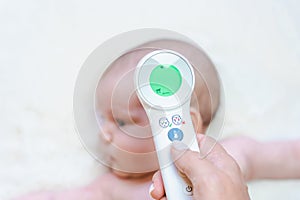 Temperature baby child sick. Doctor check cold flu baby care health from electronic thermometer. Child sick, kid health