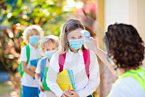 Temperature check at school. Child in mask