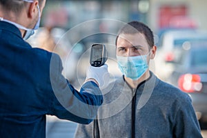 Temperature check at a supermarket of man, grocery store with thermal imaging camera. Image monitoring scanner to monitor the body