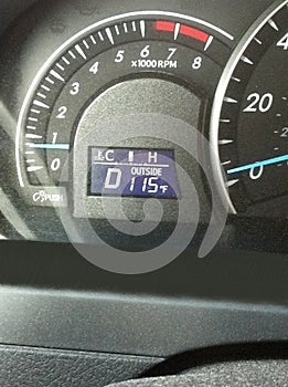 Temperature gauge and tachometer on hot day