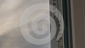 Temperature Thermometer Outside the Window and Changing Weather in Timelapse