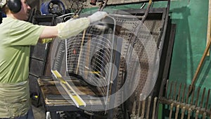 Tempered automotive glass.Work takes the glass in hand and takes.