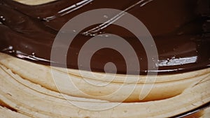 Tempering of the chocolate on the wooden surface.