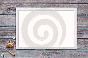 Template of blank poster in wooden frame on rustic wooden background with seashells