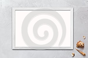 Template of blank poster in wooden frame on rustic wooden background with seashells