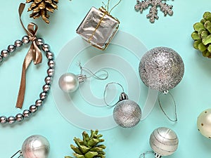 Template with Christmas decorations on a blue background, Christmas balls, cones, a gift box, a chain, all of them are in silver
