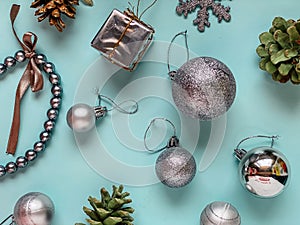 Template with Christmas decorations on a blue background, Christmas balls, cones, a gift box, a chain, all of them are in silver