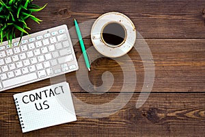 Template for contacts, background for contact information. Lettering Contact us in notebook on office work desk with