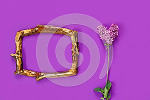 Template for design with vintage wooden frame and branch of lilac in the shape of heart