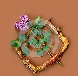 Template for design with vintage wooden frame and branch of lilac in the shape of heart