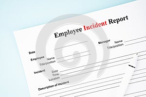 The Template of an Employee incident report form document and and pen on blue background