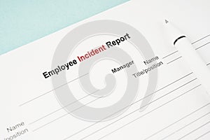 The Template of an Employee incident report form document and and pen on blue background