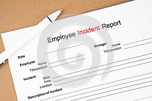 The Template of an Employee incident report form document and and pen on wooden background