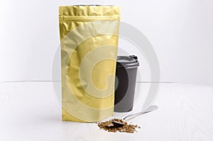 Template of instant coffee packaging. Paper cup with hot beverage, spoon full of instant coffee.Preparation of hot and tasty coffe