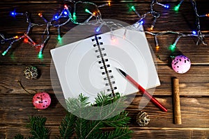 Template letters with New Year and Christmas greetings or a list of gifts. Opened notebook is located at an angle. Happy New Year