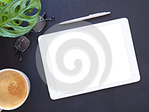 Template, mock-up digital tablet pc computer with blank white screen and pen, coffee cup, glasses, little tree on black workplace