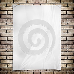 Template- White crumpled rectangle Poster on grunge brick wall