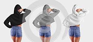 Template of white, gray, black hoodie on a posing girl in short shorts, set of women`s clothing for design presentation