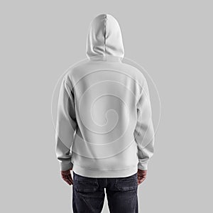 Template white hoodie oversize on a man in a hood, in dark jeans, back view. Male sweatshirt mockup isolated on background