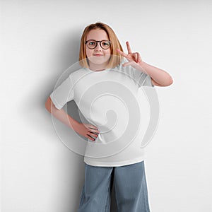 Template of a white kid shirt, a t-shirt on a cheerful girl, wear for a child, isolated on a background, front view