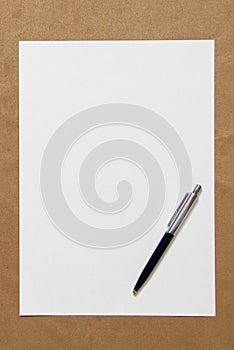 Template of white paper with pen lies on light brown cloth background. Concept of business plan and strategy. Stock