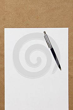 Template of white paper with pen lies on light brown cloth background. Concept of business plan and strategy. Stock