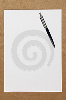 Template of white paper with pen lies on light brown cloth background. Concept of business plan and strategy. Stock